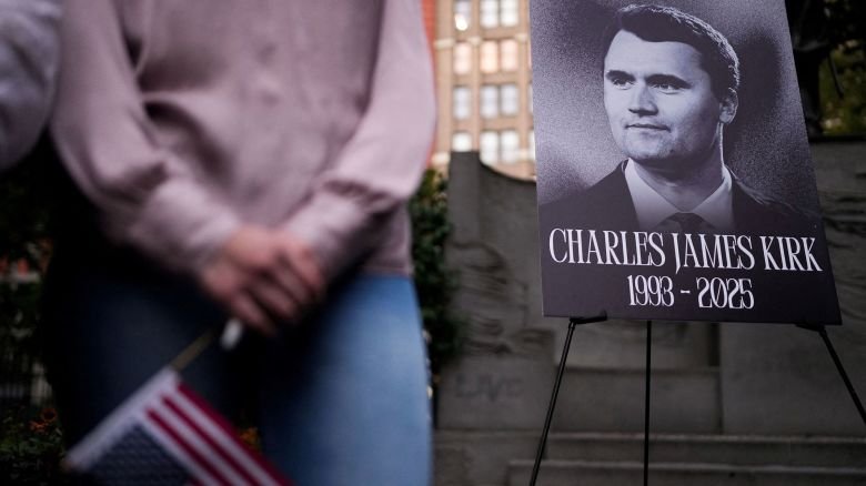 A person holds a US flag as people gather during a vigil for Charlie Kirk at Madison Square Park in New York on September 12.