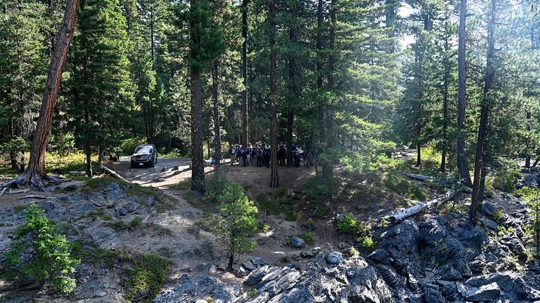 This photo provided by FBI Seattle shows several law enforcement agencies participating in the search for Travis Decker, who was charged with murder and kidnapping, at Rock Island Campground near Leavenworth, Wa. on Monday, August. 25, 2025. (FBI via AP)