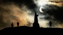 NUUK, GREENLAND - MARCH 29: The statue of Dano-Norwegian Lutheran missionary Hans Egede is silhouetted during a partial solar eclipse on March 29, 2025 in Nuuk, Greenland. (Photo by Leon Neal/Getty Images)
