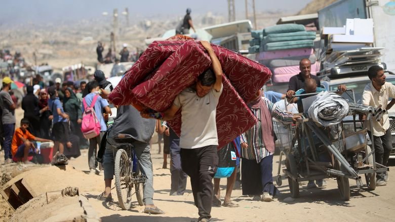 Palestinians from Gaza City flee south with their belongings, near the Nuseirat refugee camp in the central Gaza Strip on Friday, as the Israeli military operated in the area.
