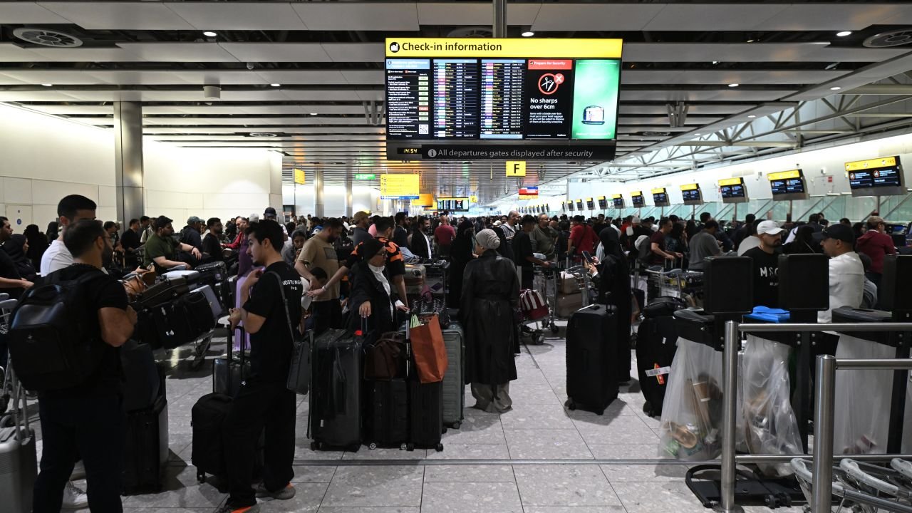 Travellers wait in terminal 4 at Heathrow Airport, west of London on September 20, 2025.